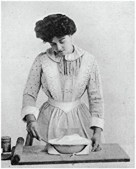 Baking Collection: Trim the edge of the tart with share knife. Date: 1907