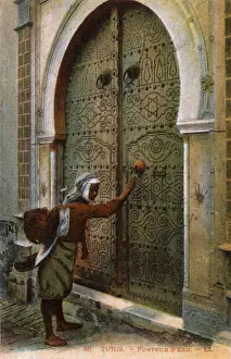 Smaller Prints: Tunis - Tunisia, water carrier knocking on ornate door