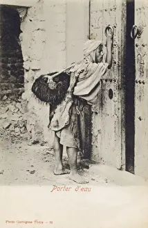 Knocking Prints: Tunisia, Water Carrier knocking at an impressive wooden door