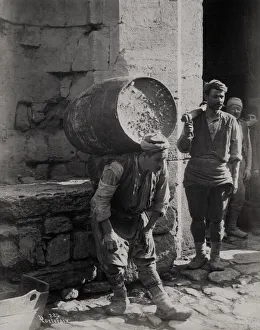 Turkish porter carrying barrel, Constantinople, Istanbul Tur
