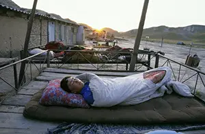 Habitat Prints: Turmen - a family sleeps outside on plank-beds - sunrise