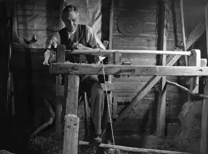 Turning Prints: Turning wood on a pole lathe, which is turned by a foot pedal. Date: 1930s