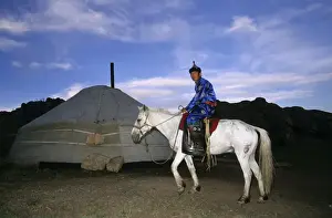 Dusk Prints: Tuvinian in traditional clothes on a horse wearing