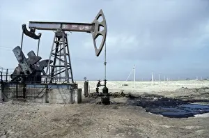 Habitats Prints: A typical oil-pump on an oil-well with a puddle