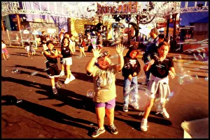 Chasing Collection: USA - Children chasing soapbubbles Santa Monica beach