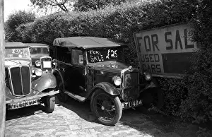 Motors Prints: Two used cars for sale including a Morris Eight (left) and an Austin seven AJ tourer (right)