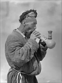 Xinjiang Prints: A Uyghur man smoking an elaborate pipe
