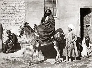 Veiled woman on a donkey, Egypt, circa 1880s