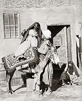 Mounting Prints: Veiled woman mounting a donkey, Egypt, circa 1880s