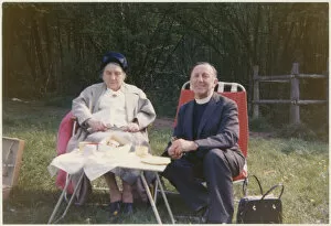 Vicar and elderly parishioner having a picnic tea