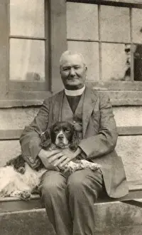 Vicars Prints: Vicar with a spaniel dog on a bench
