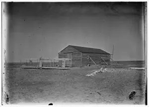 Kitty Prints: Front view of glider outside camp building at Kitty Hawk, No