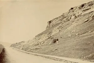 View at side of Little Ormes Head, North Wales, with a man standing partway up the slope Date: circa 1889