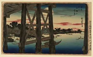 View of full moon from the scaffolding beneath a bridge, wit