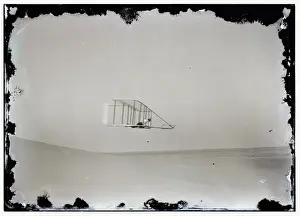 Side view of Wilbur gliding in level flight, moving to right
