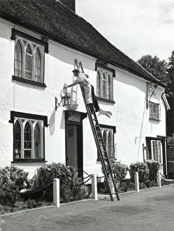 Rendering Prints: The village decorator, busy painting the front of The Fox Inn