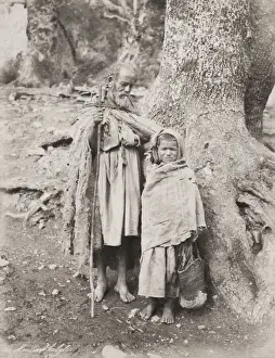 Vintage 19th century photograph: poorly dressed elederly man and child, Tunis, Tunisia, c