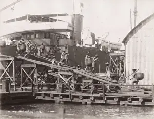 Vintage 19th century photograph: Ship discharging coal, porters, labourers, Singapore