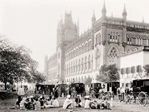 Vintage 19th century photograph: street scene India, people seated and hackney carriages