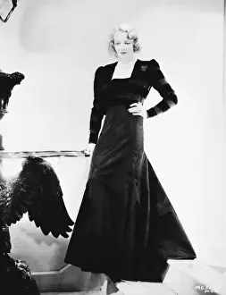 Virginia Bruce wearing an elegant evening ensemble