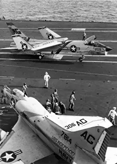 A Vought F8U Crusader manoeuvres past Douglas A-4C Skyhawk