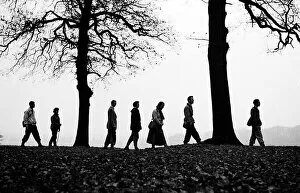 Alan Gallery: Walkers on the brow of a hill making a silhouette
