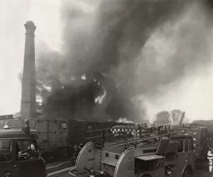 Blaze Collection: Warehouse on fire near railway line