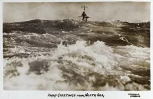 Warship peeking over North Sea waves