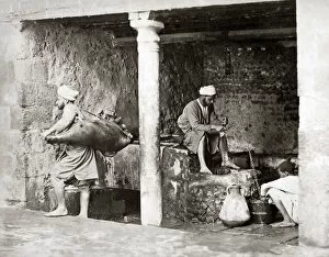 Water carriers filling their bags, Egypt, circa 1880