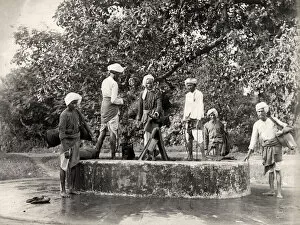 Filling Collection: Water carriers filling their skins in a well, India