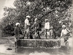 Skins Prints: Water carriers filling their skins in a well, India
