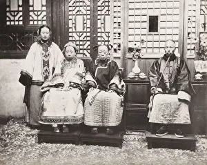 Wealthy Chinese family, ornate robes, man with pipe