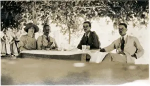 Shade Prints: Four Westerners at a table in the shade, Middle East
