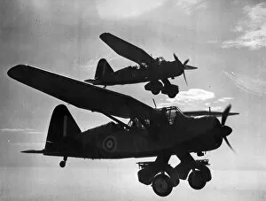 Two Westland Lysanders silouetted against the sun