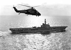 Images Dated 1st November 2016: A Westland Wessex flies over HMS Albion (R07)