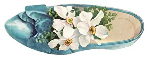 White flowers in a shoe-shaped greetings card