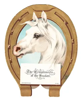 White horses head on a horseshoe-shaped Christmas card