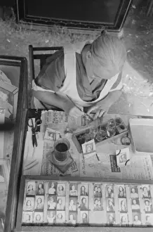 Wife of traveling photographer tinting small portraits, Nati