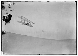 Wilbur gliding down steep slope of Big Kill Devil Hill; Kitt Wilbur gliding down steep slope of Big Kill Devil Hill; Kitt