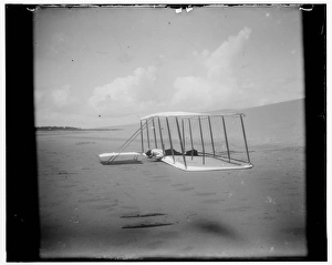 Wilbur Wright in prone position on glider just after landing Wilbur Wright in prone position on glider just after landing