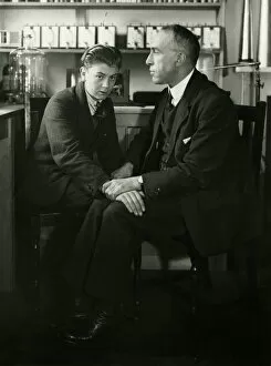 Austrian Collection: Willi Schneider when young seated with Harry Price