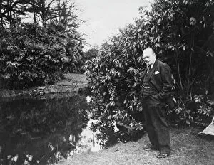 Manor Collection: Winston Churchill by a lake at Chartwell
