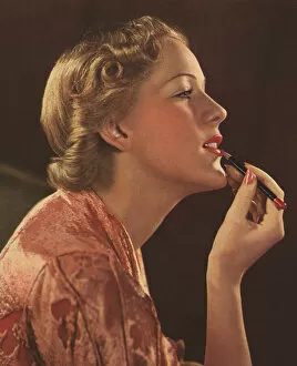 Applying Gallery: Woman applying lipstick