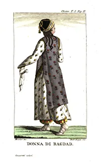 Woman of Baghdad in everyday dress of botanical-print robes, harem pants and sandals. Illustration by Mounier from Guillaume-Antoine Olivier's Travels in the Ottoman Empire, Egypt and Persia, 1801. Copperplate engraving by Dell'Acqua handcoloured by Lazaretti from Giovanni Battista Sonzogno's Collection of the Most Interesting Voyages (Raccolta de Viaggi Piu Interessanti), Milan, 1815-1817. Woman of Baghdad in everyday dress of botanical-print robes, harem pants and sandals. Illustration by Mounier from Guillaume-Antoine Olivier's Travels in the Ottoman Empire, Egypt and Persia, 1801. Copperplate engraving by Dell'Acqua handcoloured by Lazaretti from Giovanni Battista Sonzogno's Collection of the Most Interesting Voyages (Raccolta de Viaggi Piu Interessanti), Milan, 1815-1817. Date: Woman of Baghdad in everyday dress