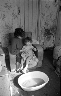 Woman bathing baby, Falls Road, Northern Ireland