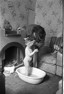 Woman bathing baby, Falls Road, Northern Ireland