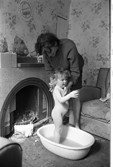 Woman bathing baby, Falls Road, Northern Ireland