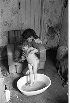 Woman bathing baby, Falls Road, Northern Ireland