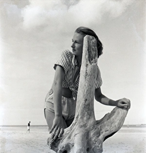Images Dated 2nd September 2016: Woman on beach with driftwood
