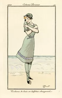 Images Dated 11th April 2019: Woman on beach in swimming costume in two-tone taffeta
